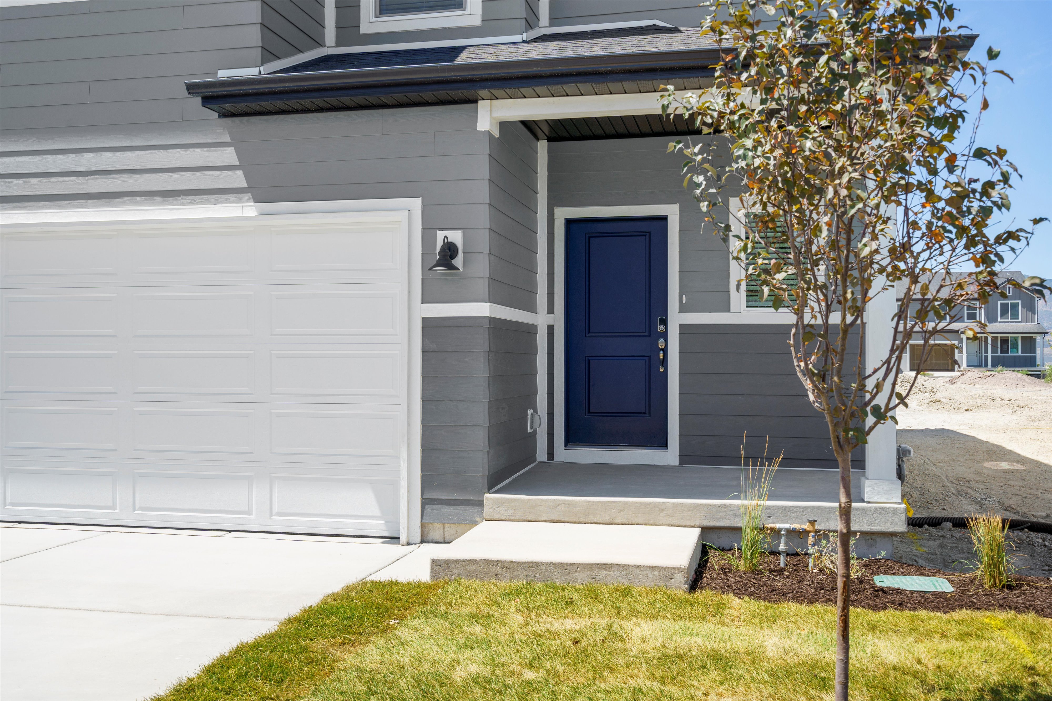**DISLCAIMER** Exterior & Interior packages may vary.Doorway to property featuring a garage