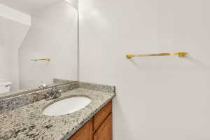 Half bath with vanity and toilet