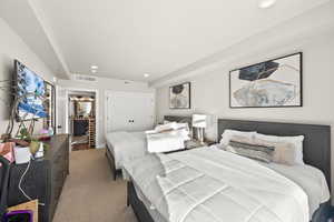 Carpeted bedroom with a closet and recessed lighting