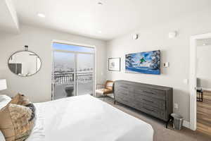 Carpeted bedroom featuring access to exterior and baseboards