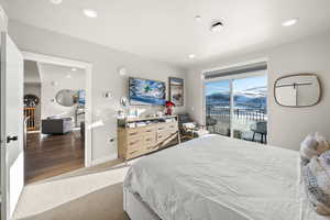 Bedroom with access to exterior, light carpet, and recessed lighting