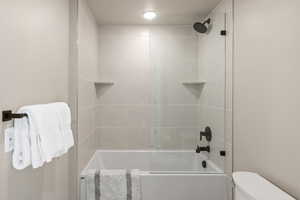 Bathroom with bathing tub / shower combination and toilet