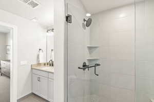 Bathroom featuring vanity and a shower stall