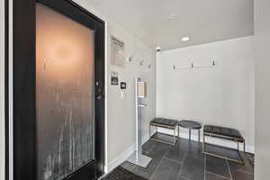 Mudroom with recessed lighting and baseboards
