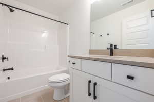 Full bathroom with vanity, light tile patterned flooring, and shower / bathtub combination