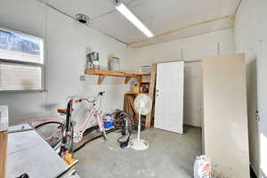Miscellaneous room with unfinished concrete flooring