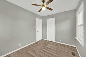Unfurnished bedroom with wood finished floors and ceiling fan