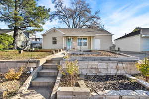 Ranch-style house with a shingled roof and a porch