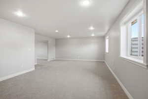 Spare room featuring light carpet and recessed lighting