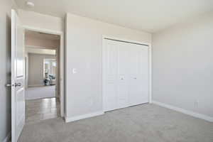 Unfurnished bedroom with carpet and a closet