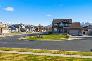 View of asphalt street featuring sidewalks, a mountain view, and a residential view