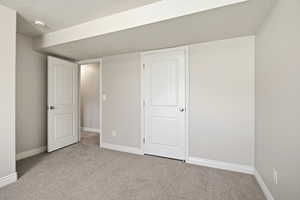 Unfurnished bedroom featuring carpet floors and a textured ceiling