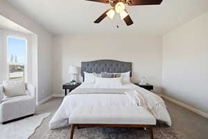 Carpeted bedroom featuring baseboards and a ceiling fan