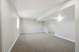 Carpeted empty room featuring a textured ceiling and recessed lighting
