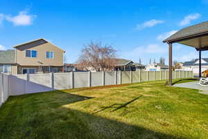 Fenced backyard with a residential view and a patio