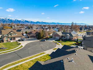 Aerial perspective of suburban area featuring a mountain backdrop