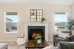 Living area with carpet flooring and a tile fireplace