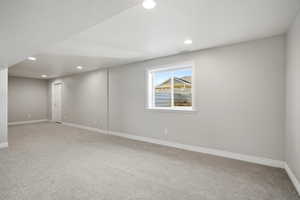 Unfurnished room featuring light colored carpet, recessed lighting, and a textured ceiling