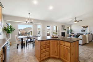 Kitchen with a fireplace, healthy amount of natural light, open floor plan, dishwasher, and recessed lighting