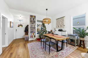 Dining space featuring light wood-style flooring and an office area