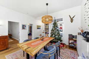 Dining space with light wood-type flooring and an office area