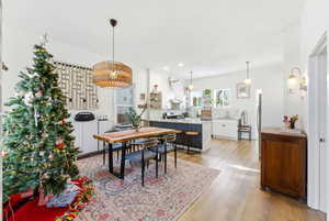 Dining space with light wood-style flooring and recessed lighting
