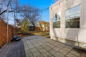 Fenced backyard with a patio and an outbuilding