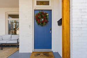 View of exterior entry with brick siding