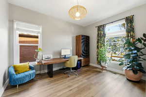 Home office featuring wood finished floors and baseboards