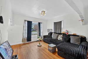 Living room with hardwood / wood-style floors and baseboards
