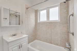 Bathroom featuring tub / shower combination and vanity