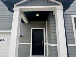 Doorway to property with a garage
