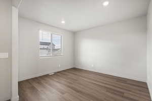 Empty room with wood finished floors and recessed lighting