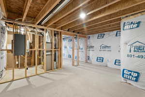Unfinished basement featuring heating unit