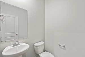 Half bath with a sink and toilet