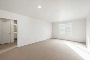 Unfurnished room with light carpet and recessed lighting
