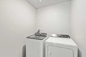 Laundry area with washer and clothes dryer