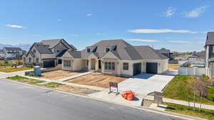 View of front of property with a residential view, a shingled roof, an attached garage, and concrete driveway