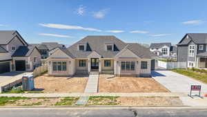 View of front facade featuring a residential view and a shingled roof