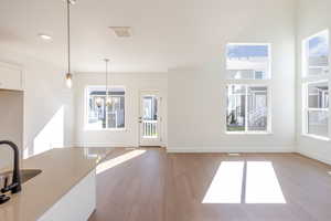 Unfurnished dining area with dark wood finished floors and baseboards