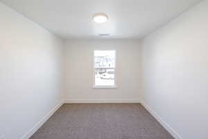 Empty room with baseboards and carpet flooring