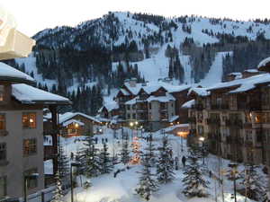 Yard covered in snow featuring a mountain view