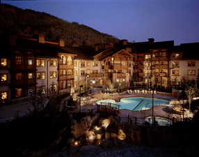 Community pool with a patio and a mountain view
