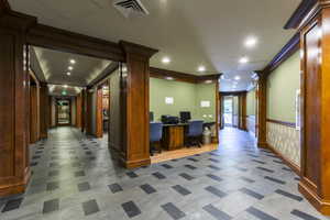 Home office with recessed lighting, wainscoting, and crown molding