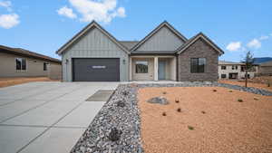 View of front of property featuring board and batten siding, concrete driveway, a porch, and an attached garage