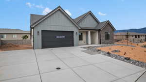 View of front of home with board and batten siding, driveway, a porch, a tile roof, and an attached garage
