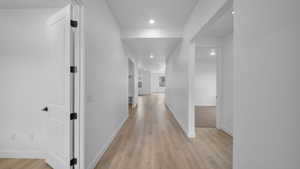 Hall featuring recessed lighting and light wood-style floors