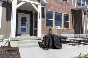 Property entrance with brick siding and an outdoor hangout area