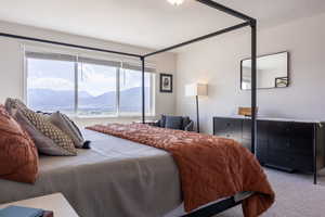 Carpeted bedroom featuring a mountain view