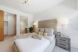 Bedroom featuring light carpet, a spacious closet, ensuite bath, a chandelier, and recessed lighting